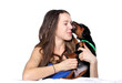 Girl kissing her doberman puppy